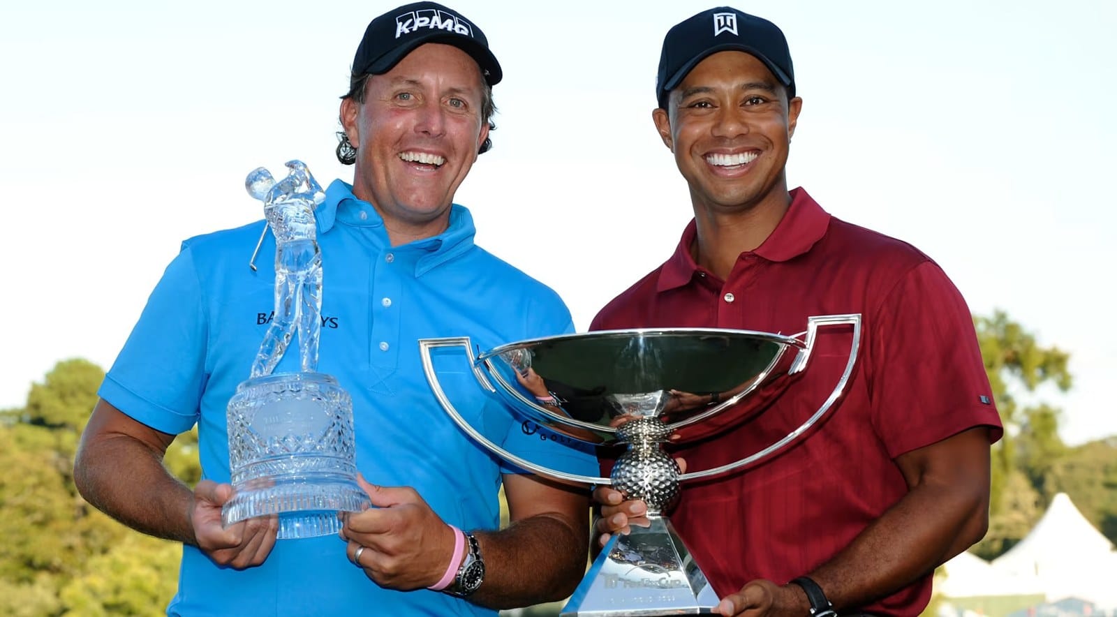 Two trophies, one confused crowd: Phil with the Tour Championship hardware, Tiger with the FedEx Cup — 2009