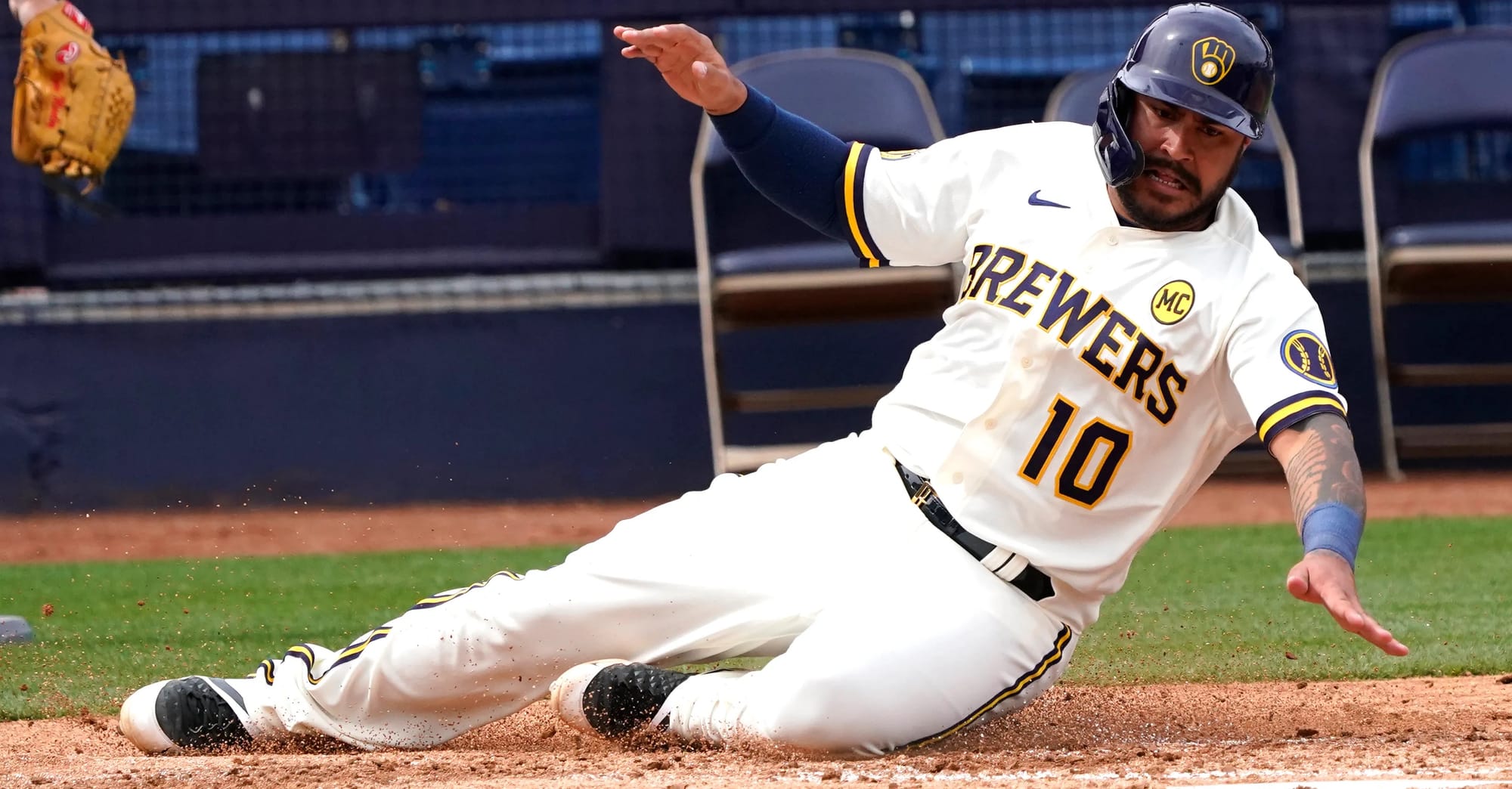 A Brewer slides home in front of empty seats, 2020.