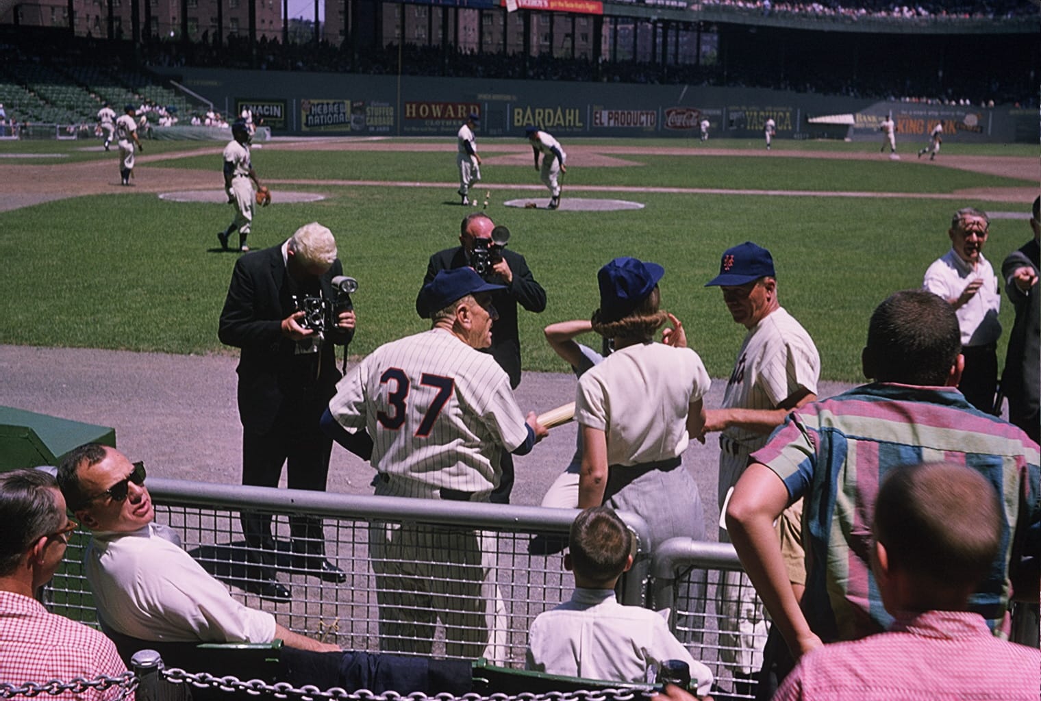 Stengel, No. 37, working the rail at the Polo Grounds — newsreel camera and all.