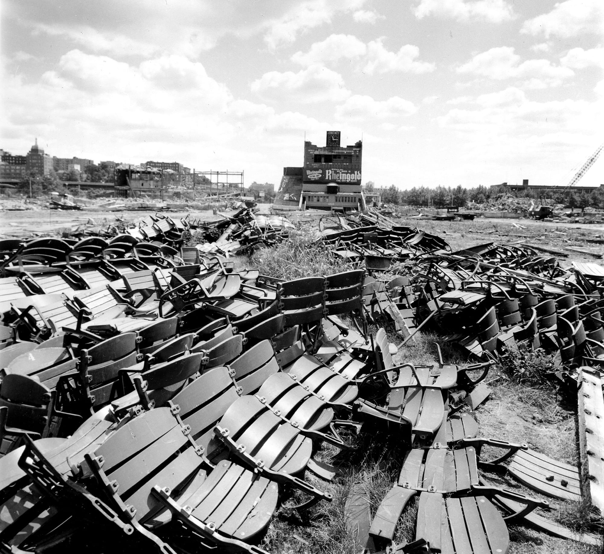 The grandstand seats, pulled out and piled in the rubble. The center field clubhouse, the Rheingold sign and the Longines clock are still standing in the distance.