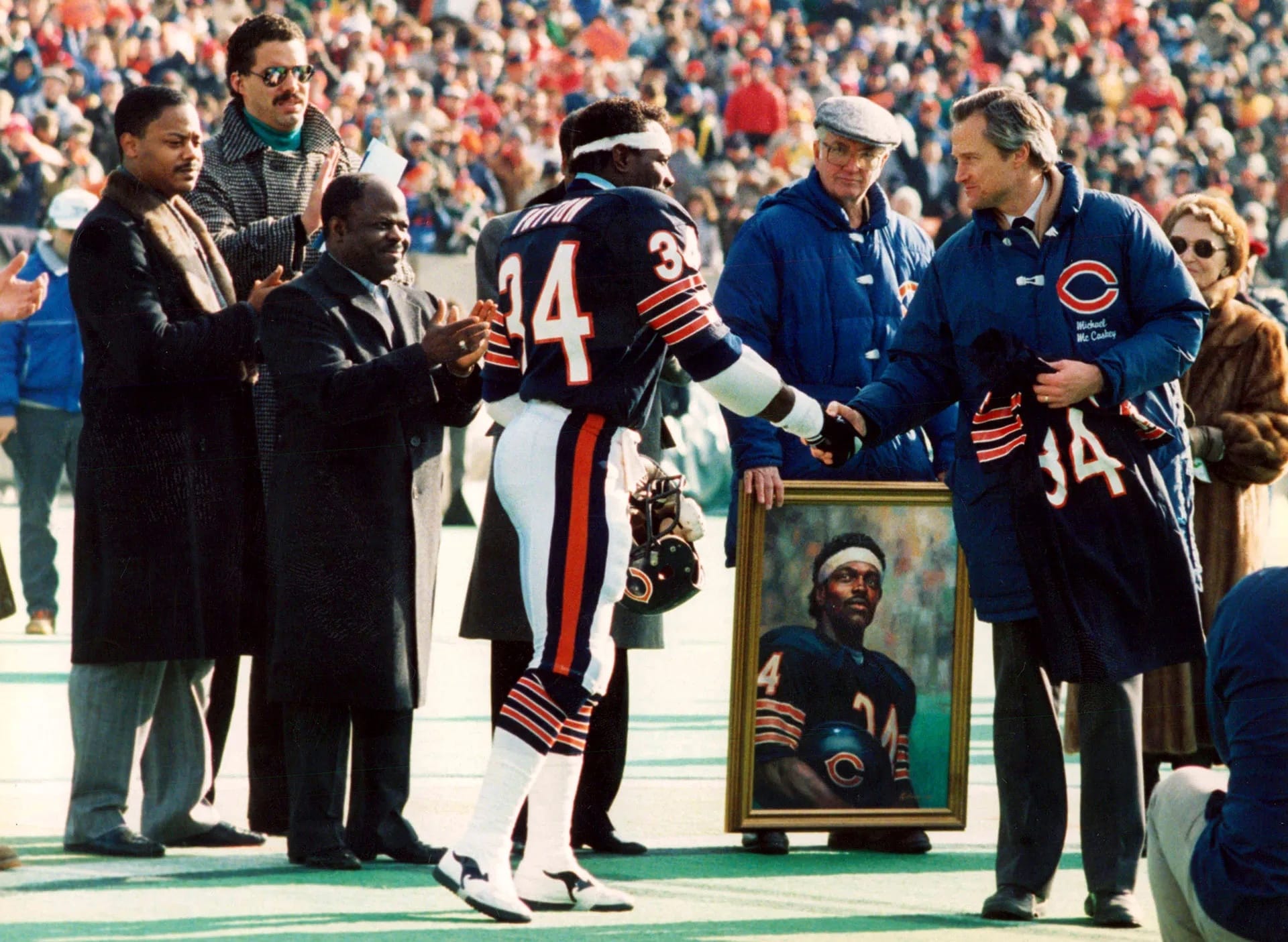 Chicago says goodbye. Bears president Michael McCaskey presents Payton with a framed No. 34.