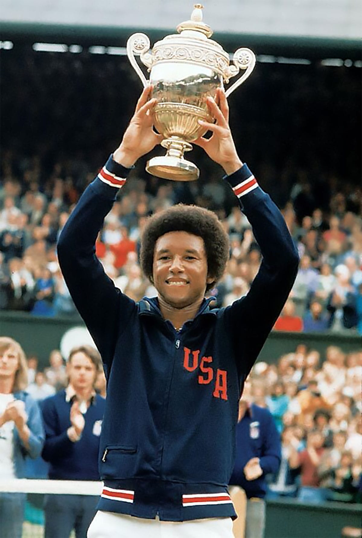Wimbledon, July 1975: 7 years after the $280 title, Ashe lifts the trophy after dismantling Jimmy Connors.