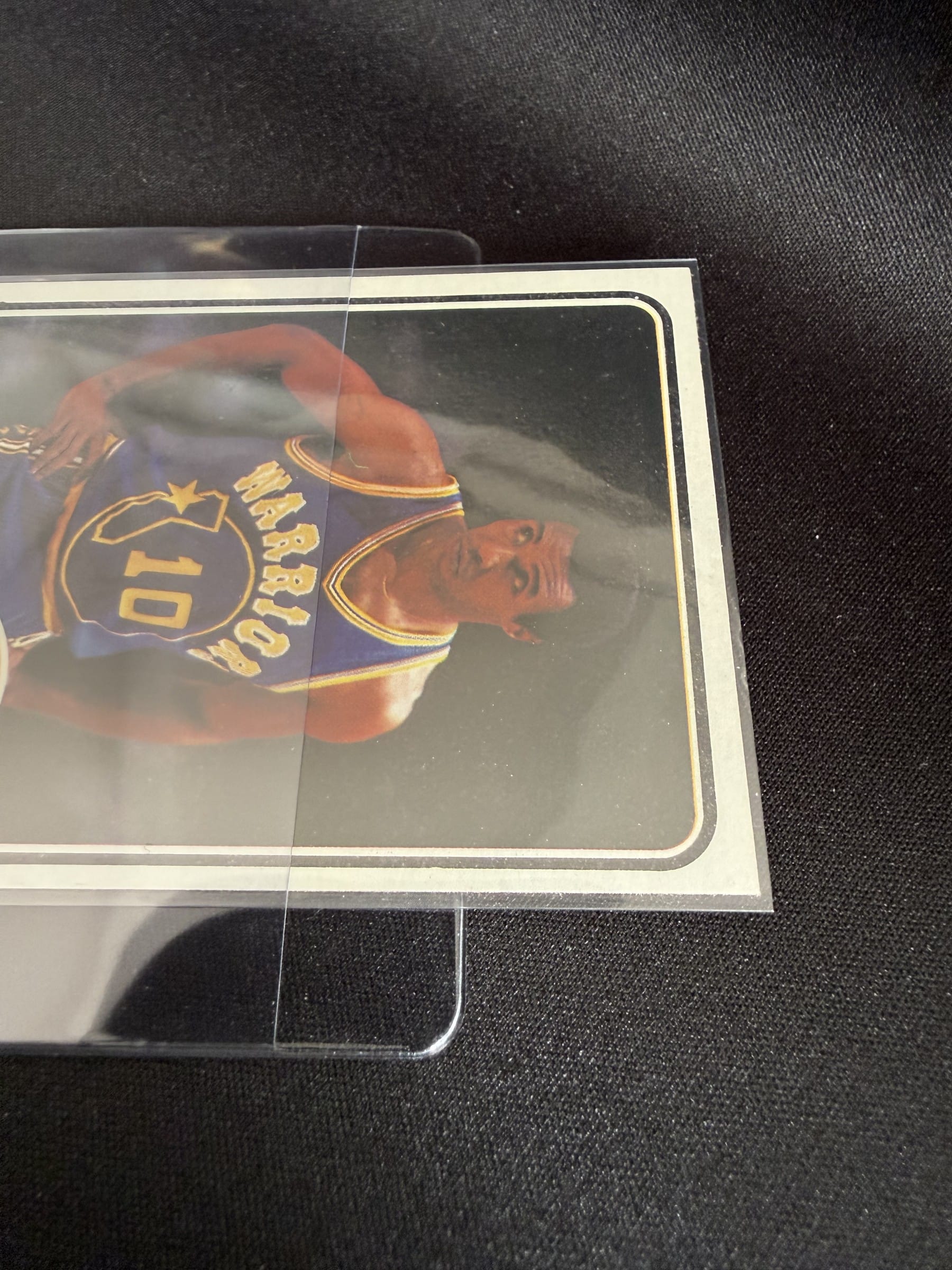 The half-inch lip on a Card Saver 1. A thumb on the card and it slides out. The card is JoJo White in his Warriors year.