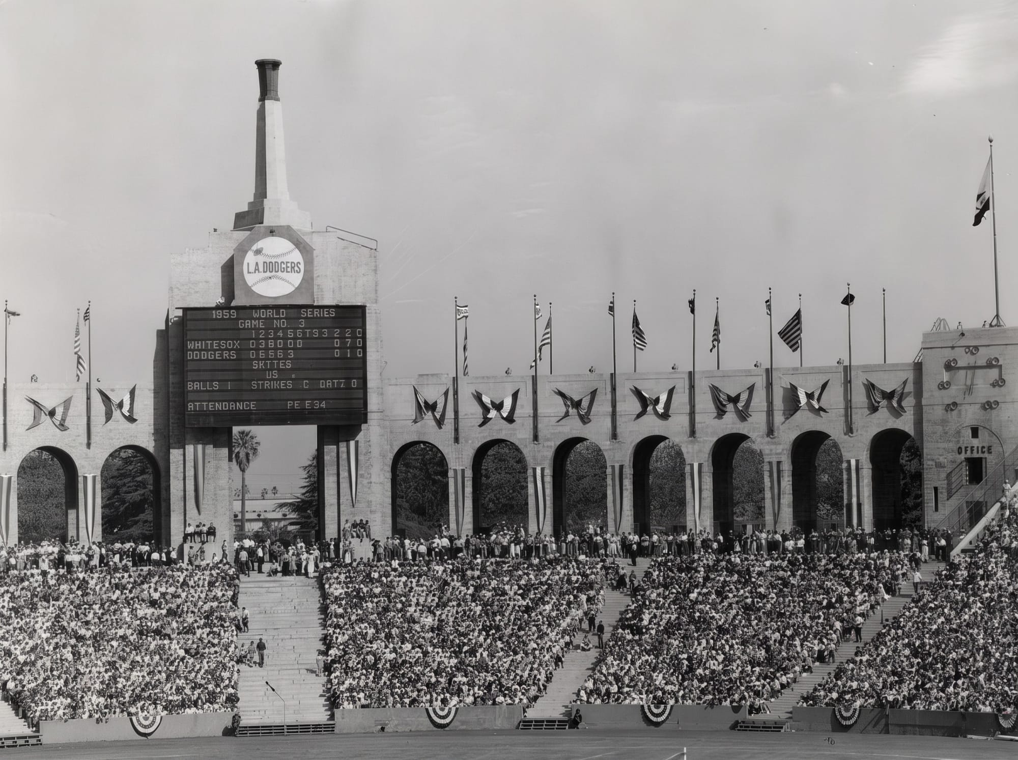 The Coliseum peristyle during the 1959 World Series. The scoreboard sat under the Olympic torch.