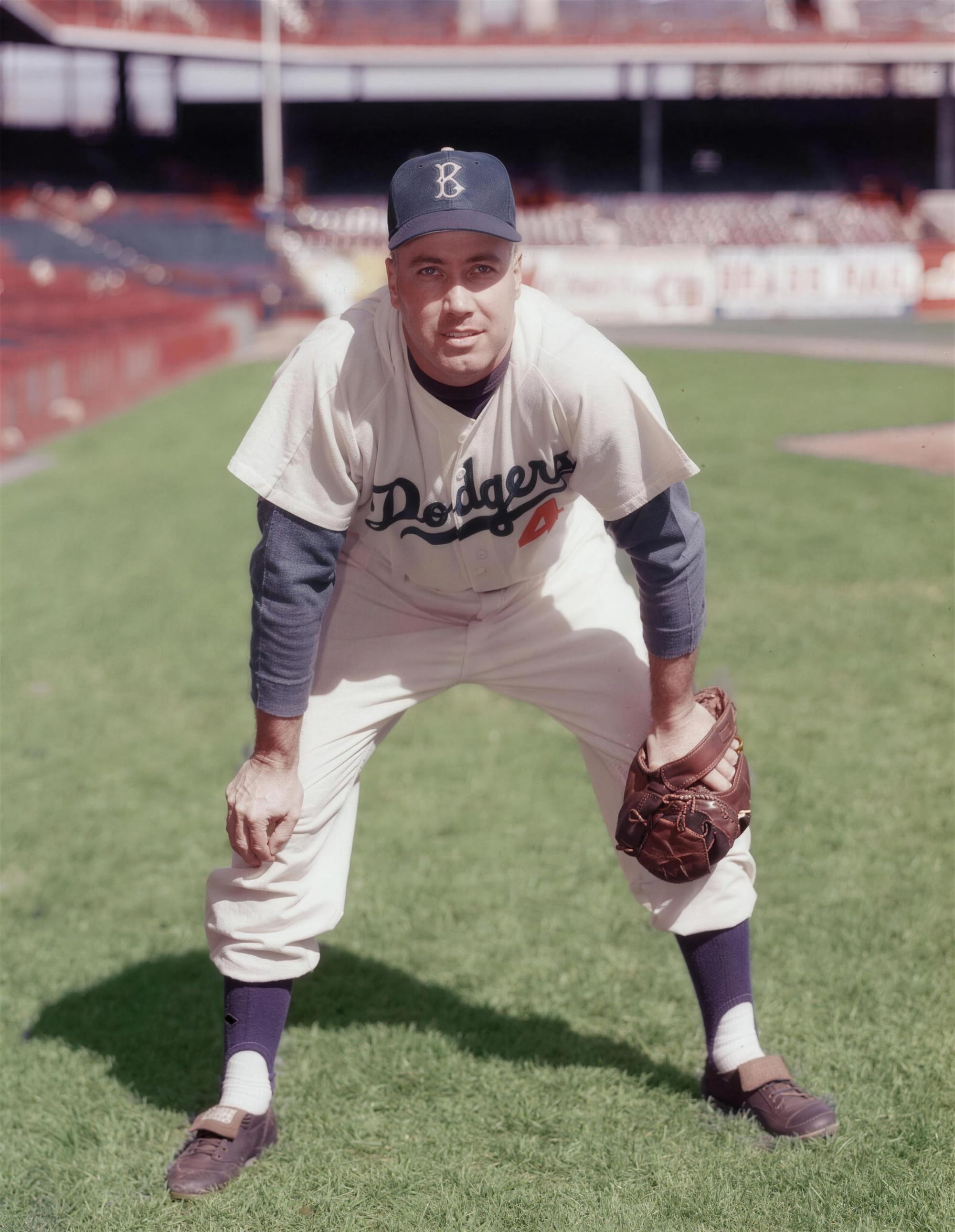 Duke Snider at Ebbets Field. Home whites, "Dodgers" in royal-blue script, the red number 4 that Brooklyn wore from 1952.