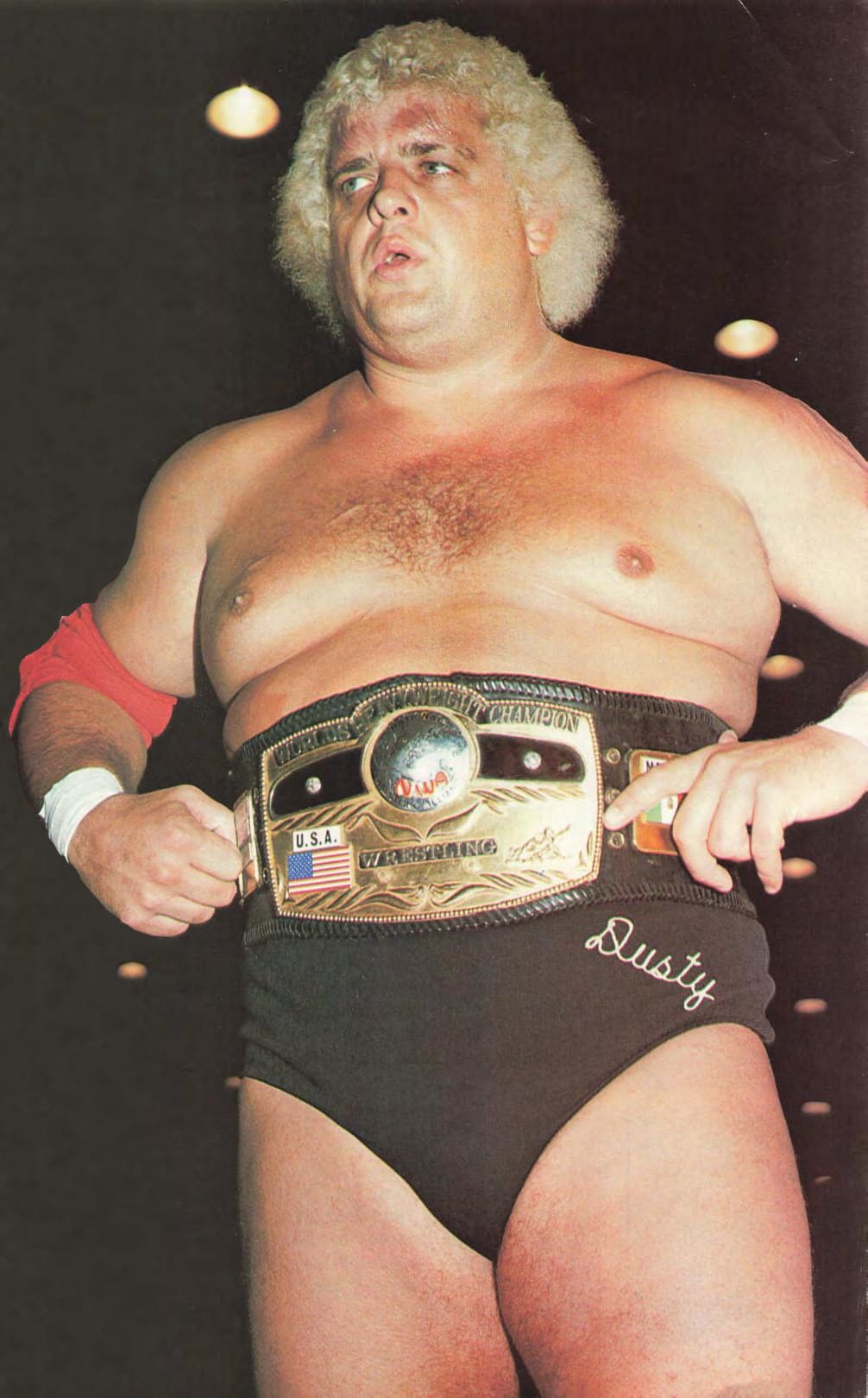 Dusty Rhodes with the NWA world title belt.