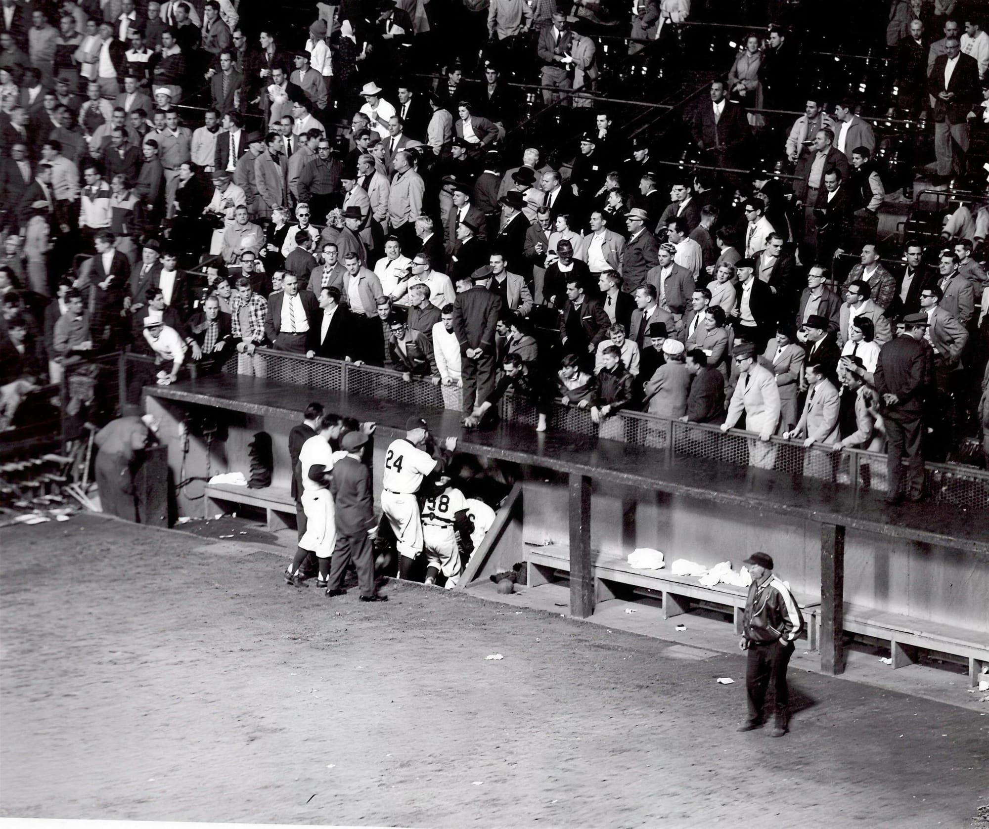 The Dodgers' dugout and the box seats behind it. Manager Walter Alston in the number 24.