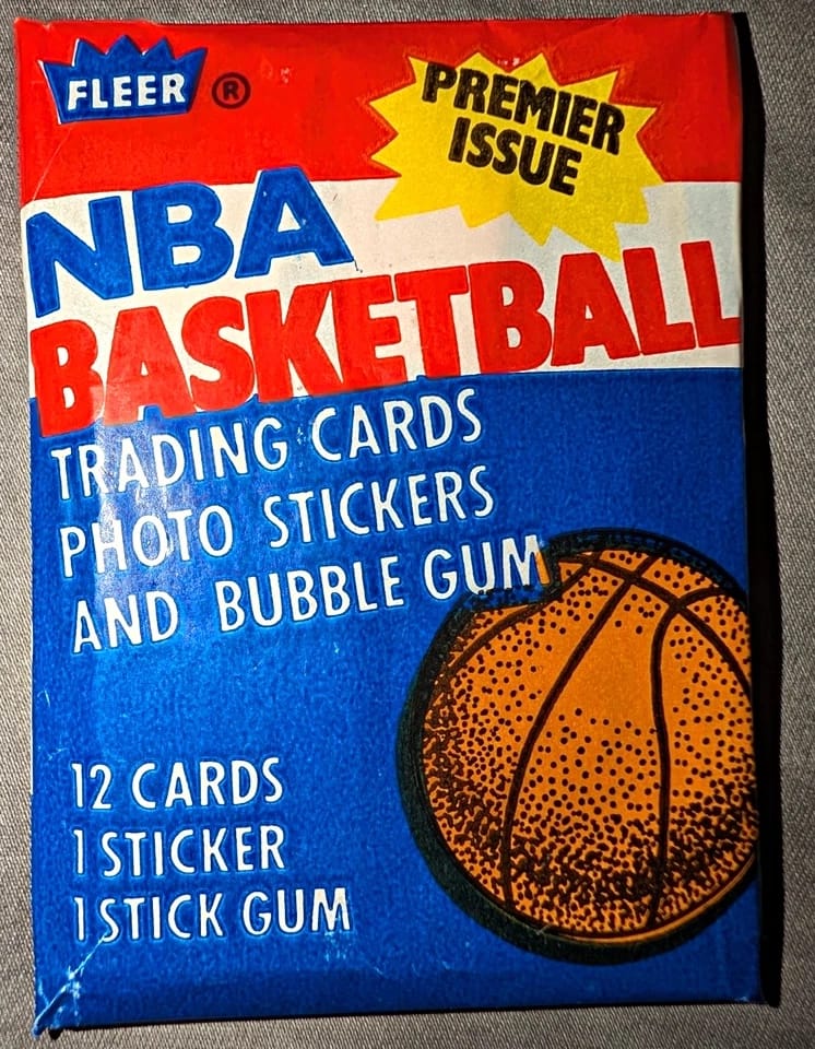 The wax pack: 12 cards, 1 sticker, 1 stick of gum. “Premier Issue” — and boxes of them sat unsold at $10.