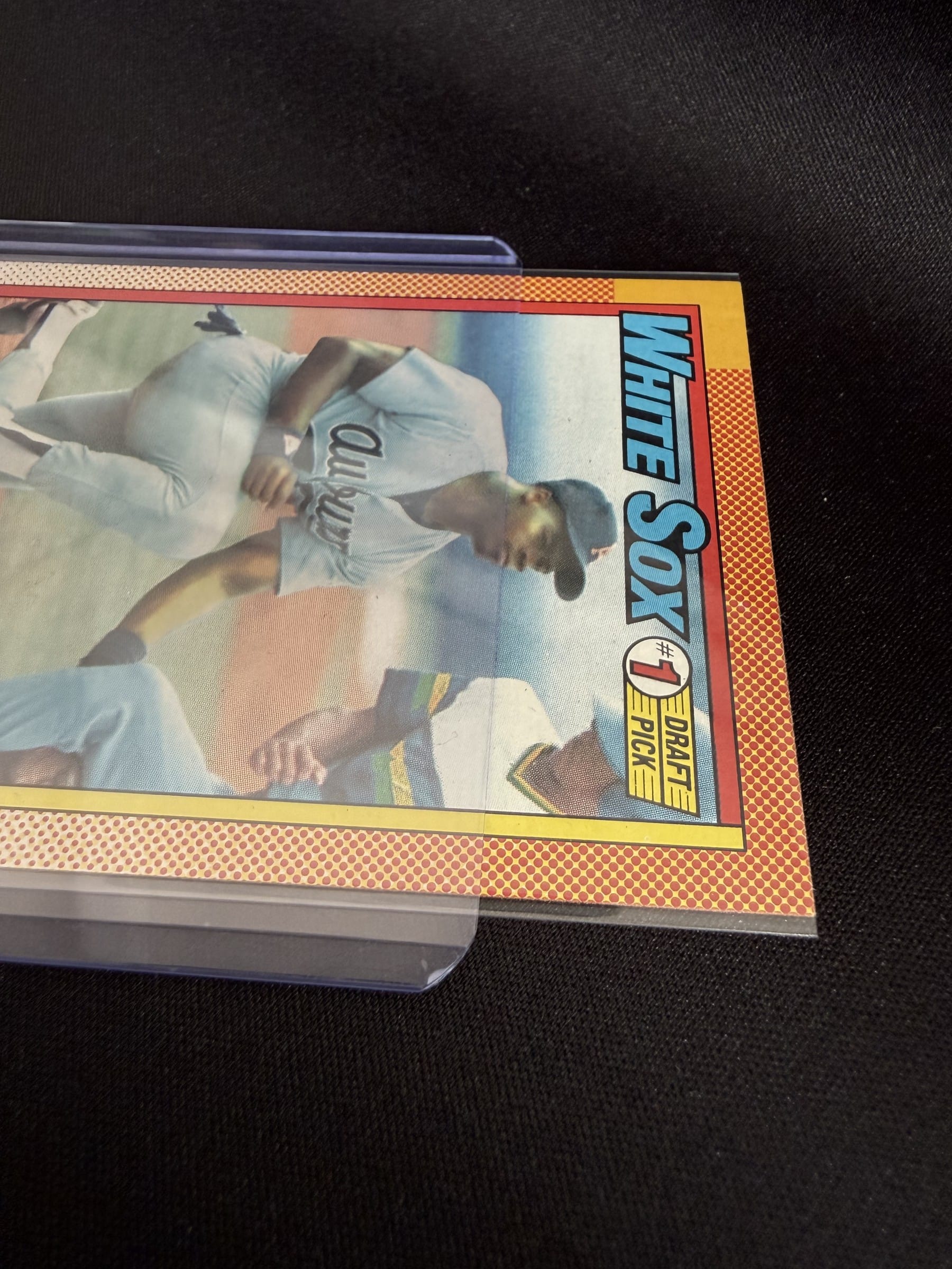 A 1990 Topps Frank Thomas going into a 35 pt top loader. Note the rigid, straight-cut mouth.