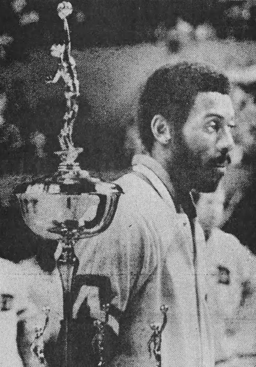 McAdoo with the 1975 MVP trophy — a decade before his 29-game Sixers goodbye.