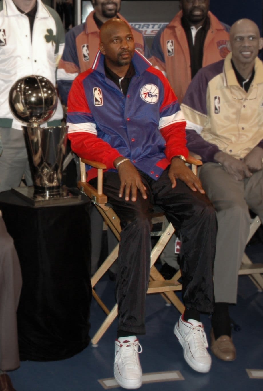 Moses Malone at a 2005 NBA legends event — back in 76ers gear. U.S. Marine Corps photo, public domain.