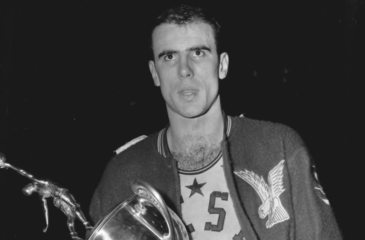 Pettit in his All-Star warmup jacket, holding a trophy.
