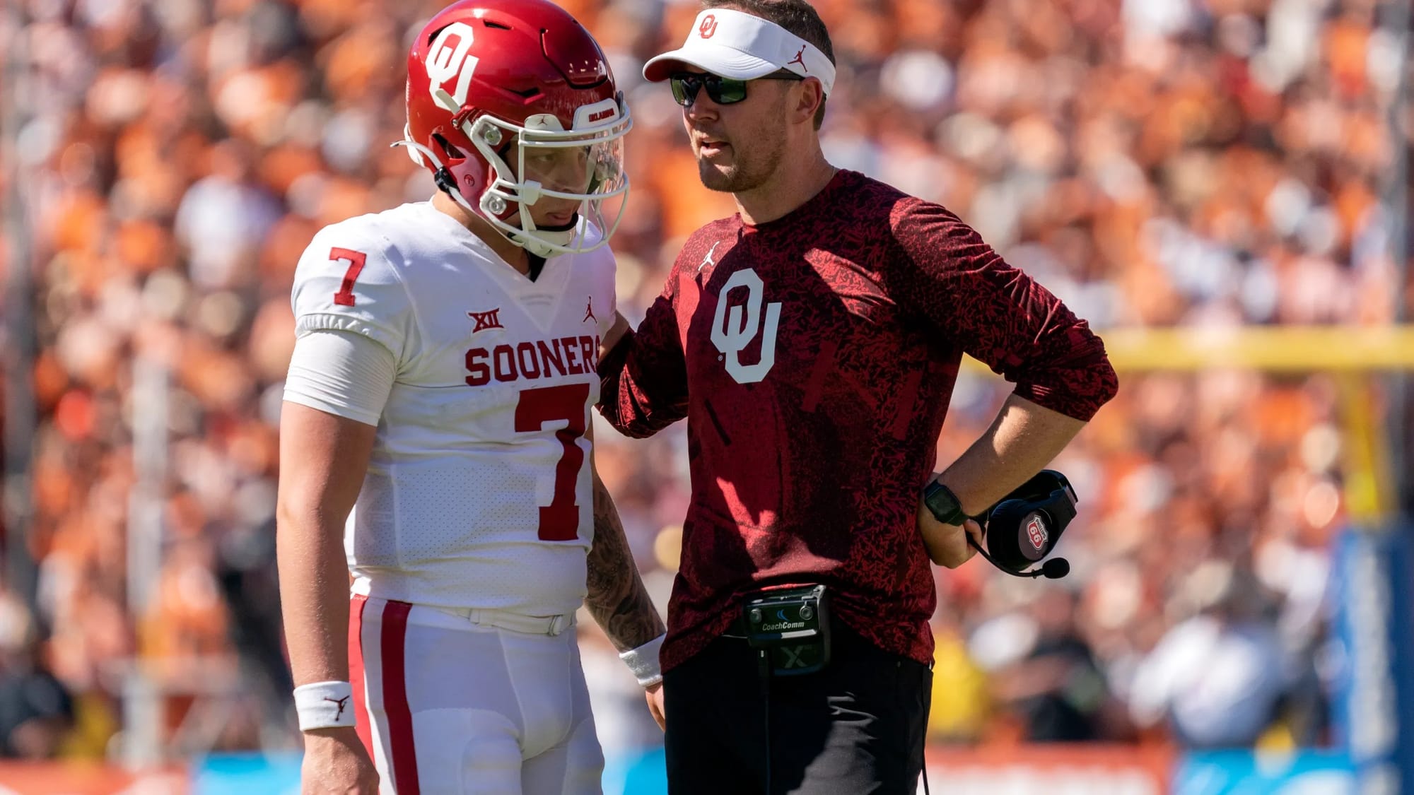 Spencer Rattler and Lincoln Riley on the sideline at the Cotton Bowl, Oct. 9, 2021. The burnt orange in the background is Texas.