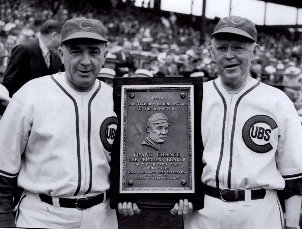 Wrigley Field, June 23, 1937: Tinker and Evers, together again, holding the plaque for Frank Chance, “The Peerless Leader.”