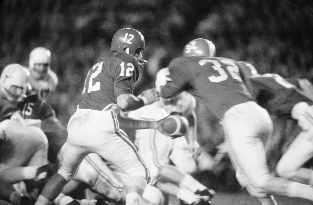 Namath, No. 12, working from under center on a bad knee.