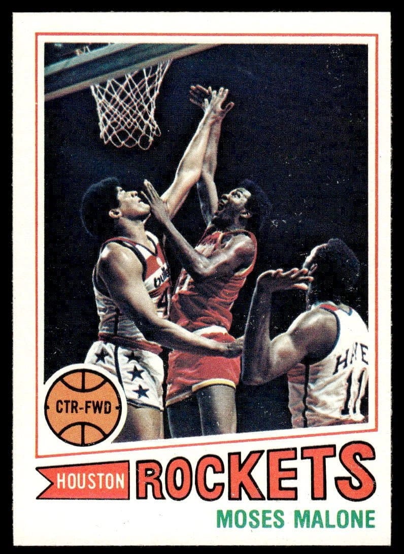 1977-78 Topps Moses Malone, contested at the rim by the stripes.