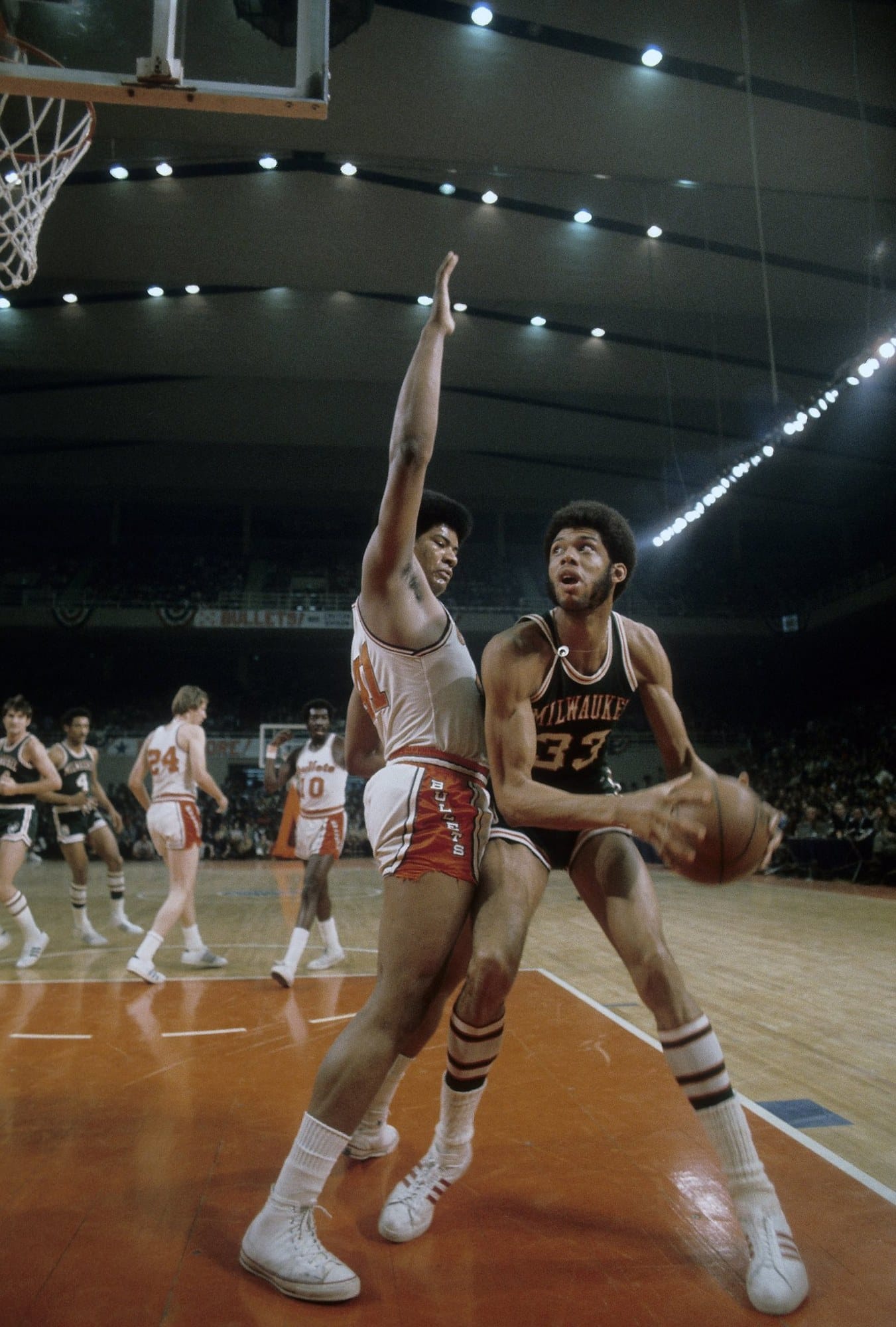 Unseld shoots over Kareem — six-foot-seven, giving up half a foot, holding position anyway.