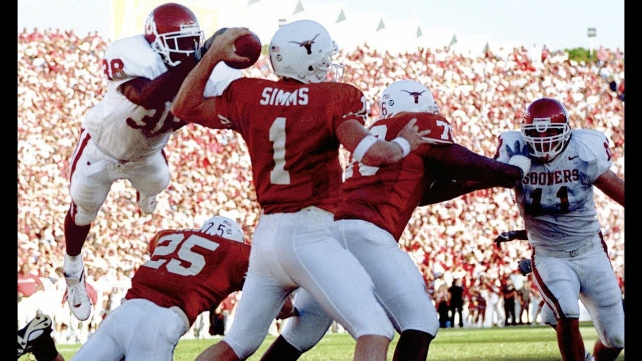 Roy Williams leaves his feet and hits Chris Simms as he throws.