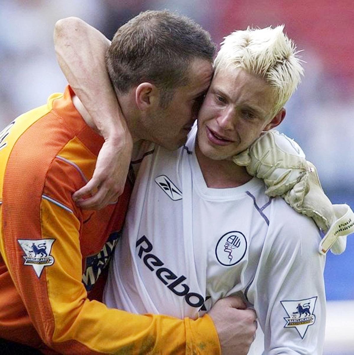 Leeds striker Alan Smith, in a Bolton shirt after the final whistle, is comforted by goalkeeper Paul Robinson at Bolton, May 2, 2004.