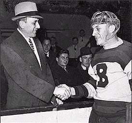 Ace Bailey (left) shakes hands with Eddie Shore before the Ace Bailey Benefit Game, Feb. 14, 1934. (Public domain, via Wikimedia Commons)