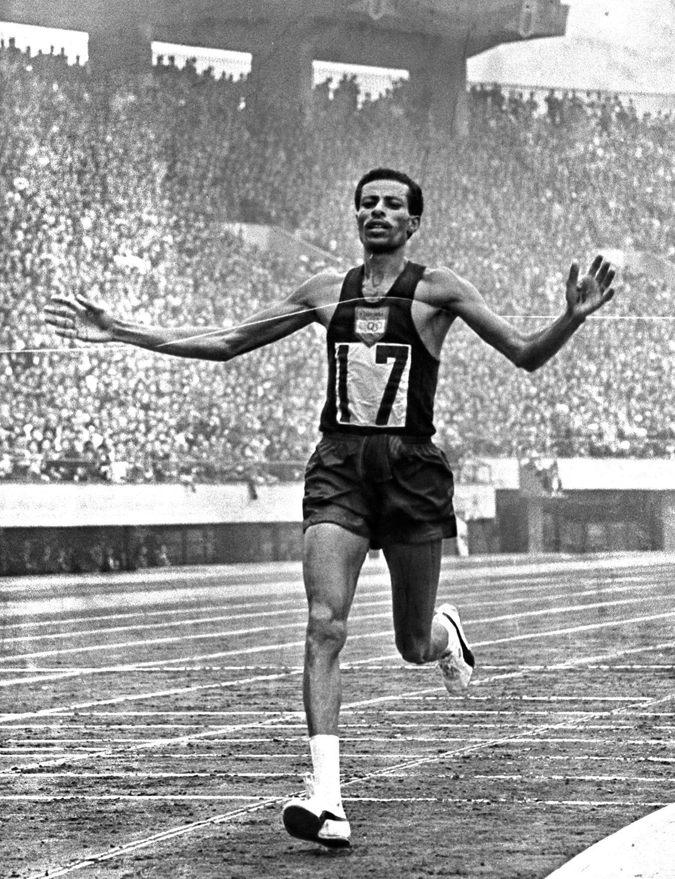Abebe Bikila finishes the marathon in a world-best 2:12:11.2, Oct. 21, 1964.