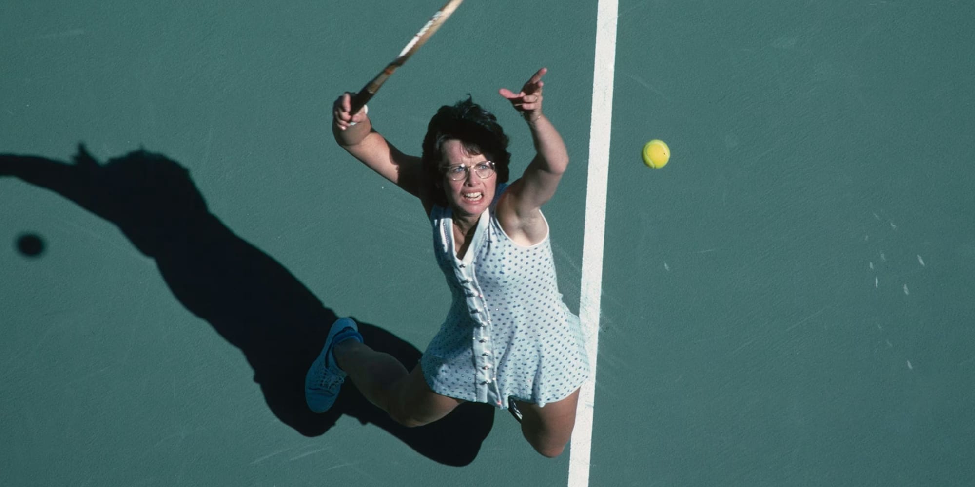 King at the top of her serve, from overhead.