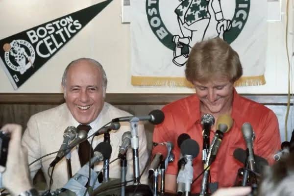 Bird with Red Auerbach at the press conference for his signing, 1979.