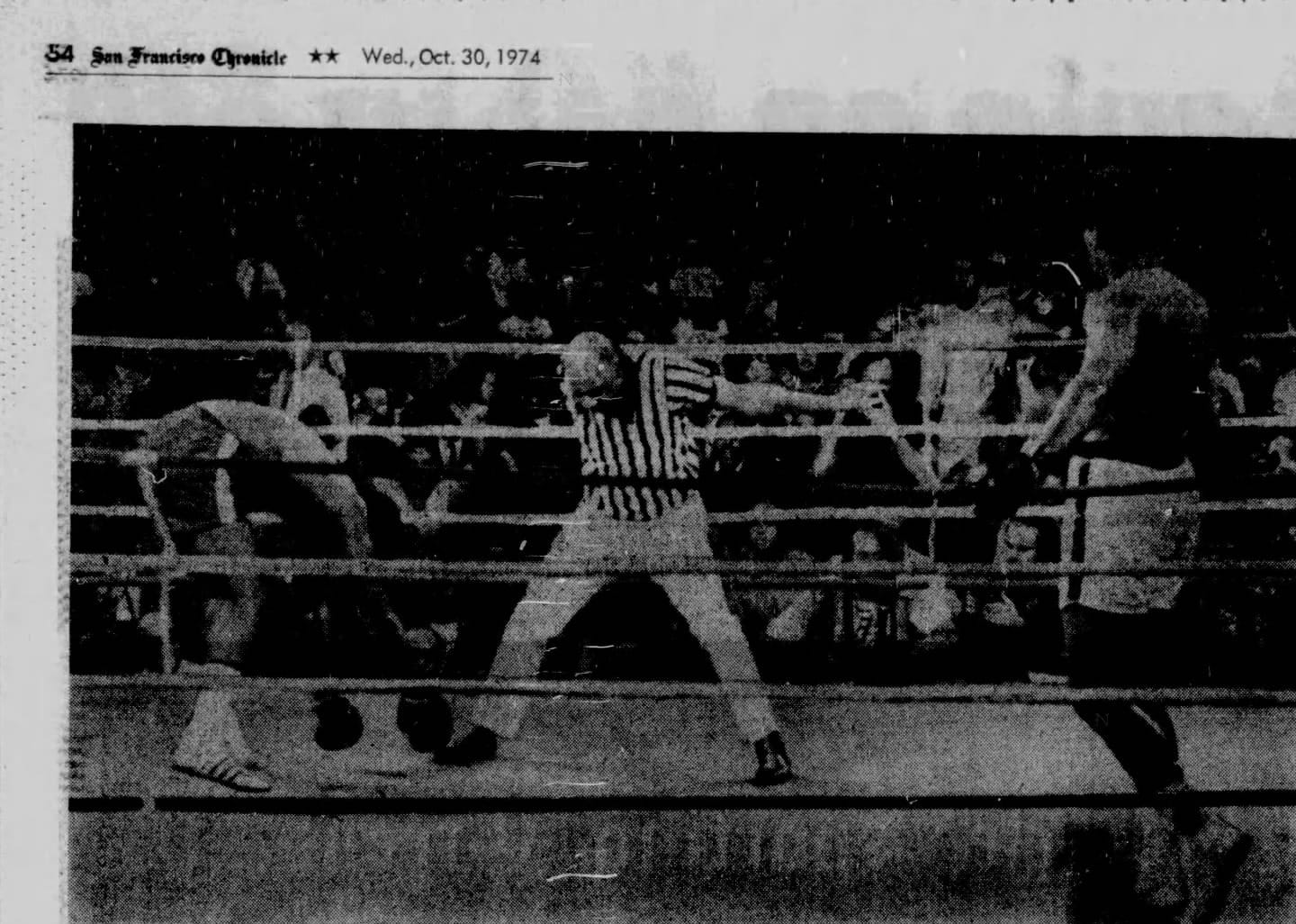 Referee Zack Clayton counts as Foreman tries to get up. (AP Wirephoto in the San Francisco Chronicle, Oct. 30, 1974, p. 54, via Newspapers.com)