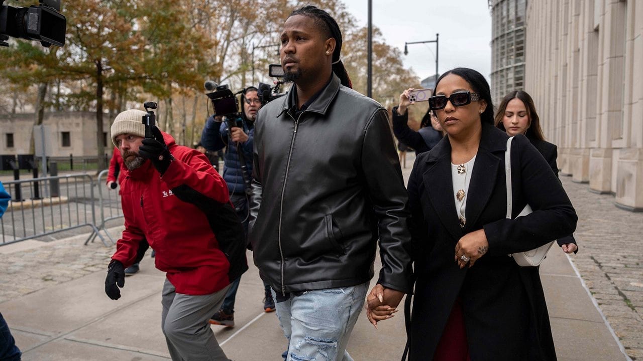 Clase walks through a crowd of photographers on his way into federal court.
