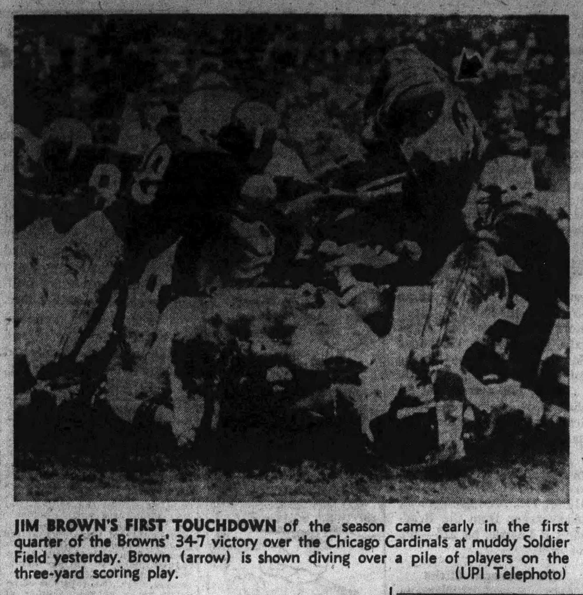 The Press's UPI photo of Brown's first touchdown, diving over the pile at Soldier Field. The paper called it a 3-yard play; the AP had it at 2.