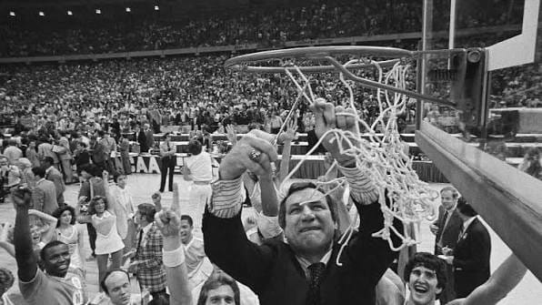 Dean Smith cuts down the net after his first national title.