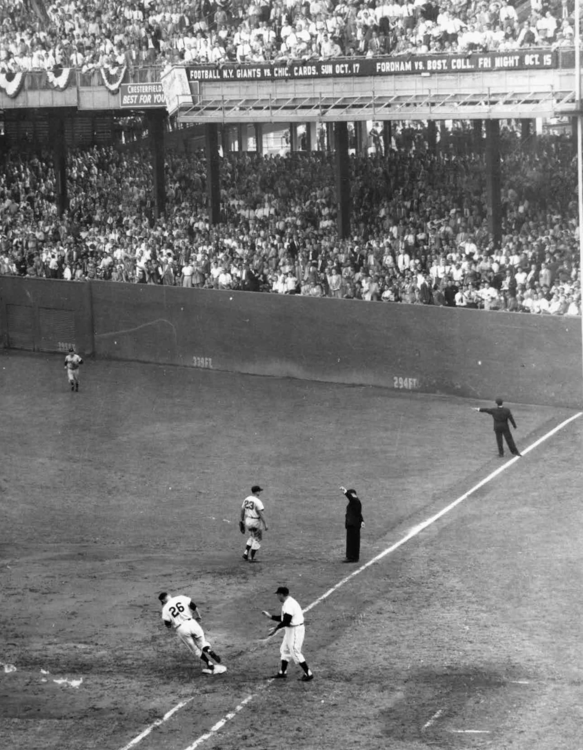 Dusty Rhodes rounds third after one of his home runs at the Polo Grounds during the 1954 World Series.