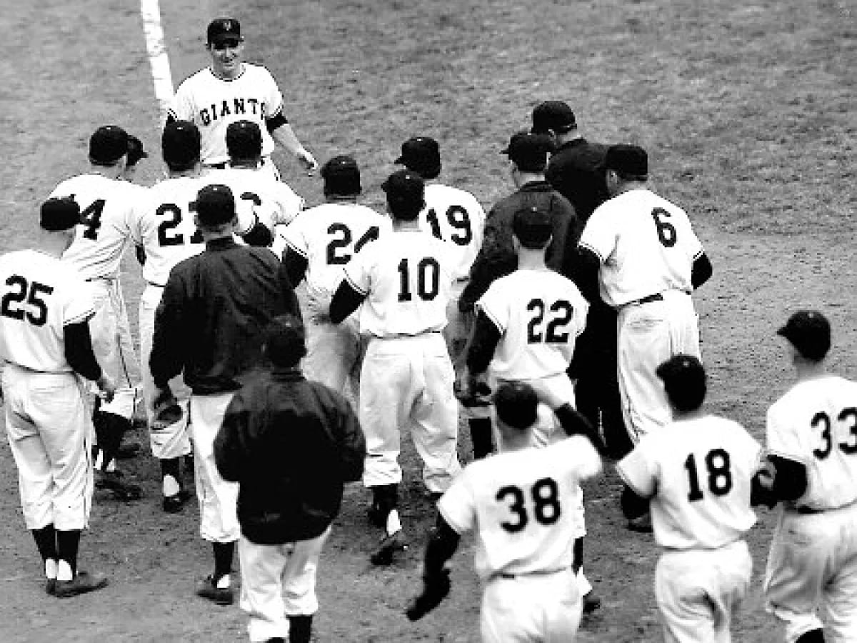 The Giants crowd home plate after Rhodes' walk-off.