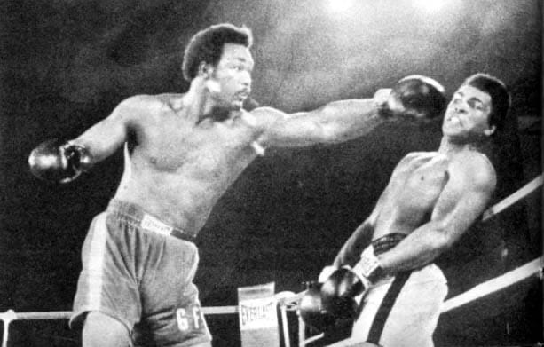 Foreman throws, and Ali leans away on the ropes in Kinshasa.