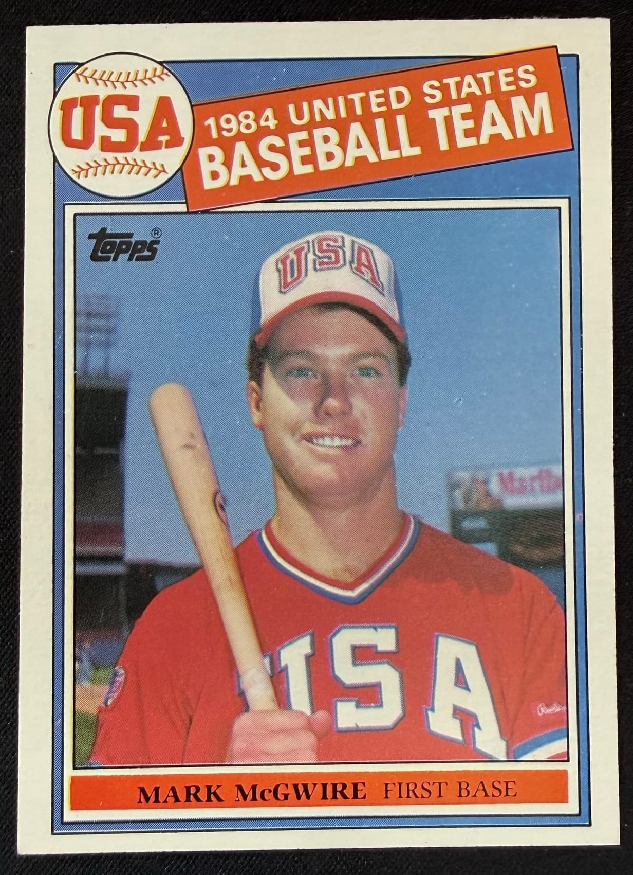 A 1985 Topps Mark McGwire, a card that's been widely counterfeited. A loupe is how you check the print.