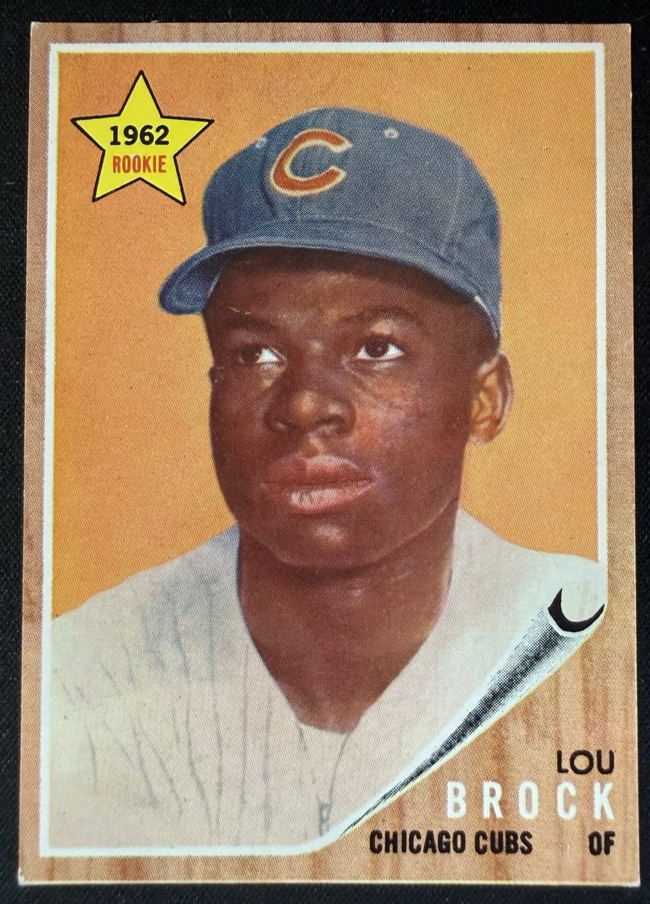 A 1962 Topps Lou Brock rookie card. On vintage cards, centering and corners are where the money is.
