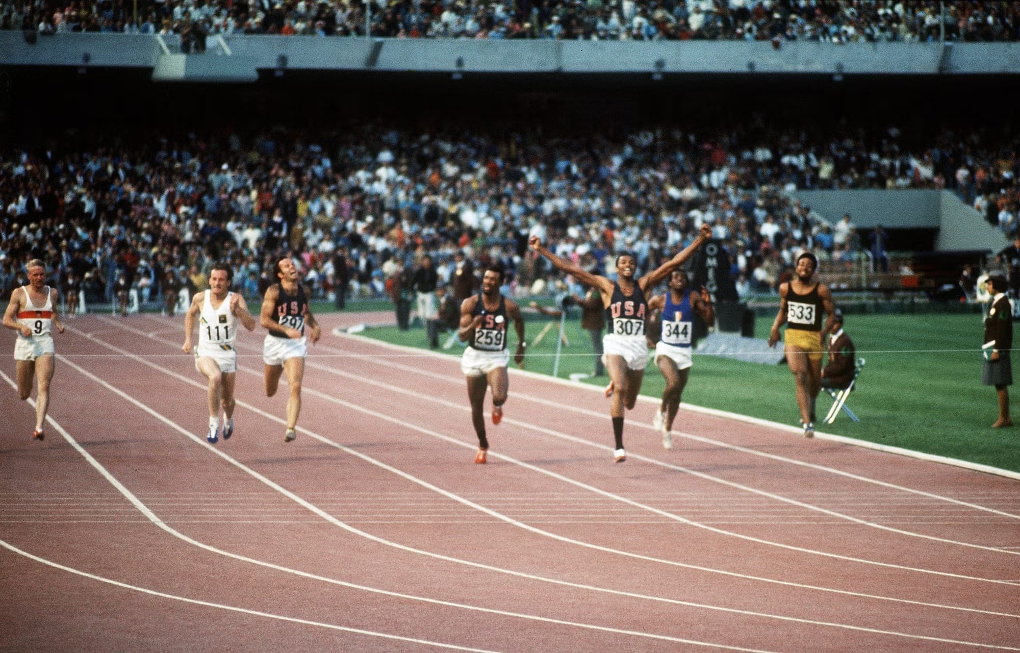 The 200-meter final at the Estadio Olímpico Universitario: Smith's arms go up before the line.