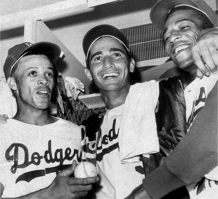 Koufax (center) celebrating with teammates in the Dodgers' clubhouse.