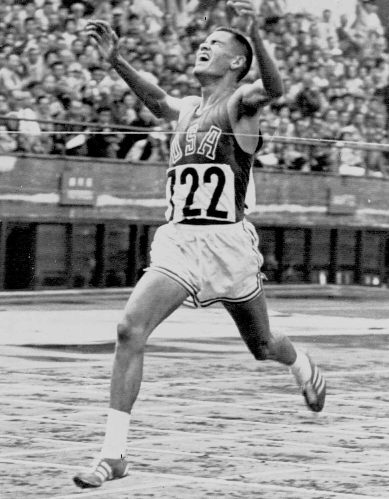 Billy Mills (722) breaks the tape in the 10,000 meters, Oct. 14, 1964.