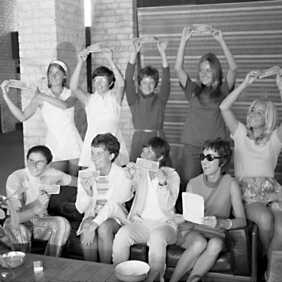 The "Original 9" hold up dollar bills, the price of their contracts with Gladys Heldman. Houston, September 1970.