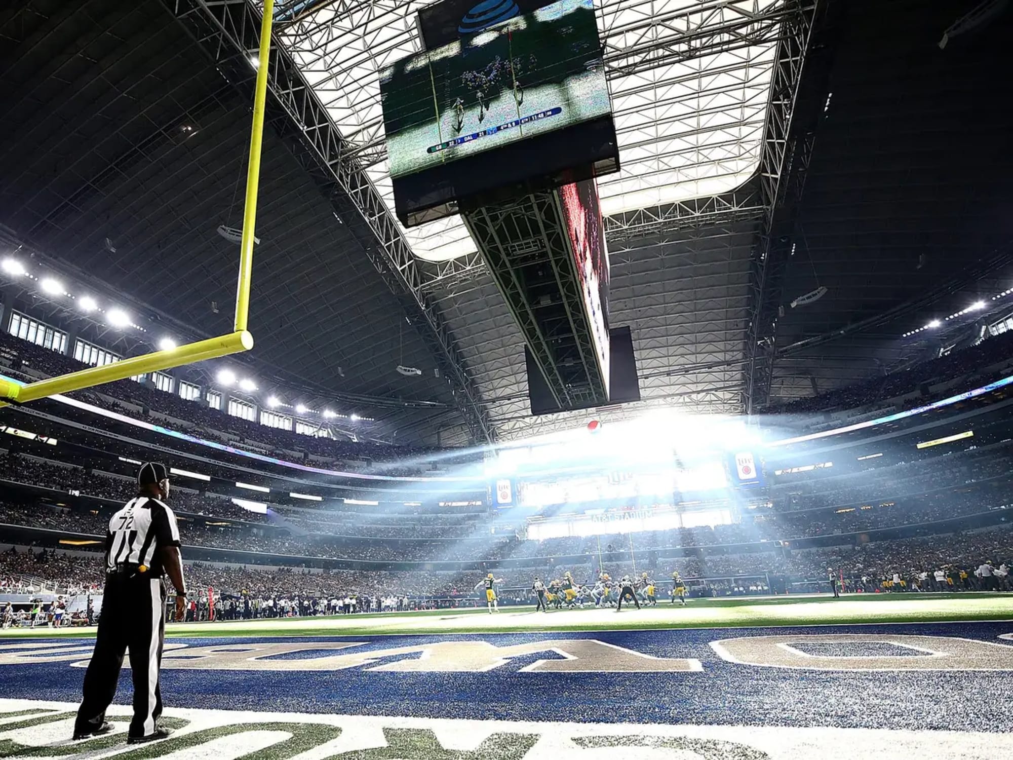 Late-afternoon sun pours through the west end zone at AT&T Stadium in Arlington, Texas.