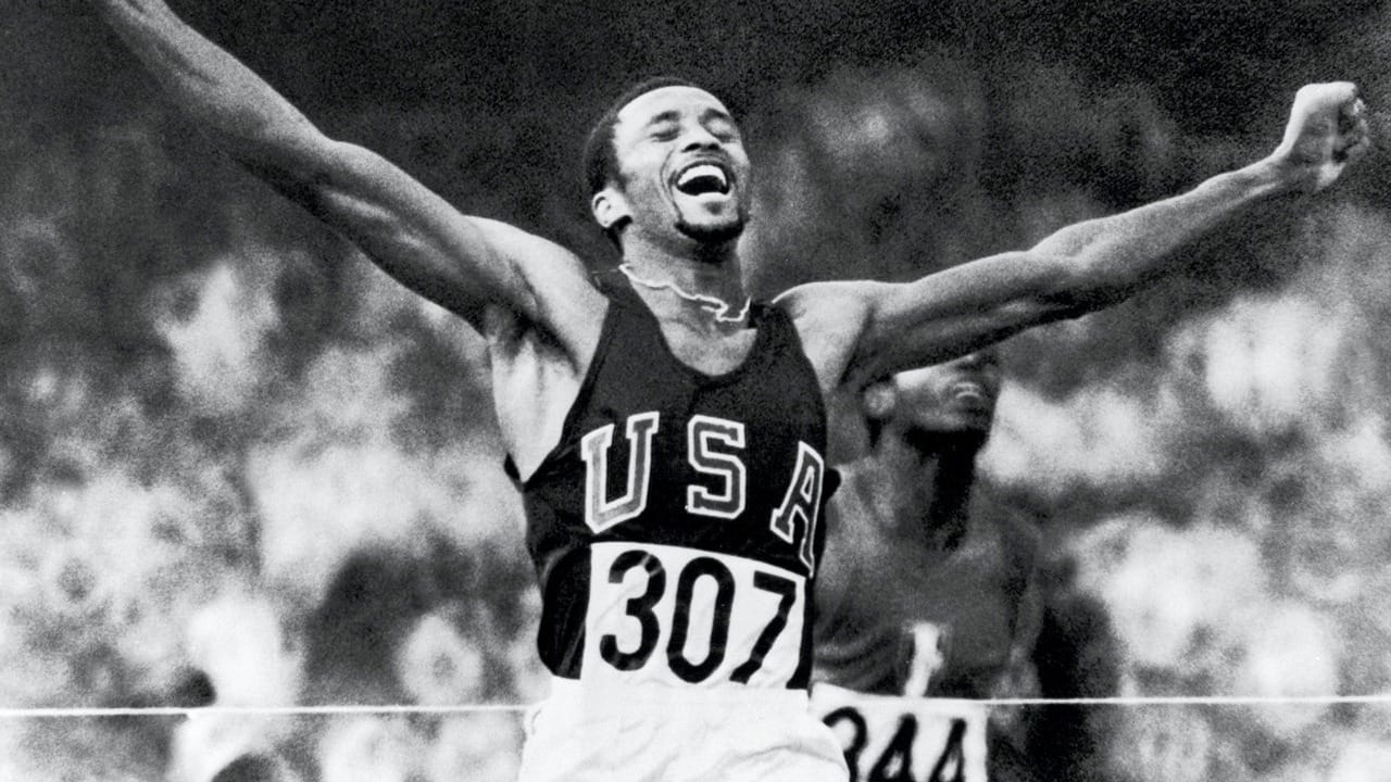 Smith crosses the line with his arms up, 19.83.