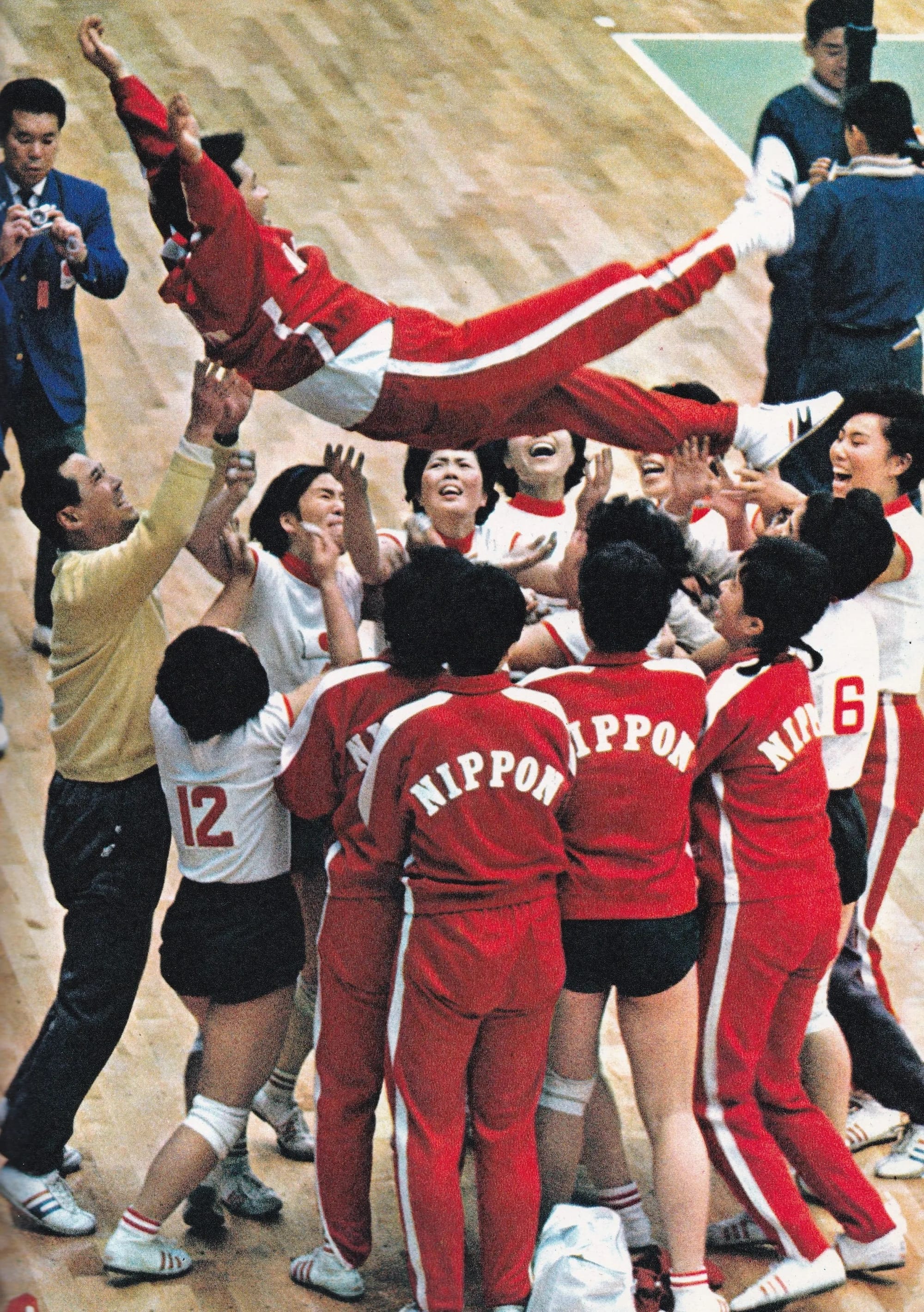 The players toss coach Hirofumi Daimatsu into the air after the win.