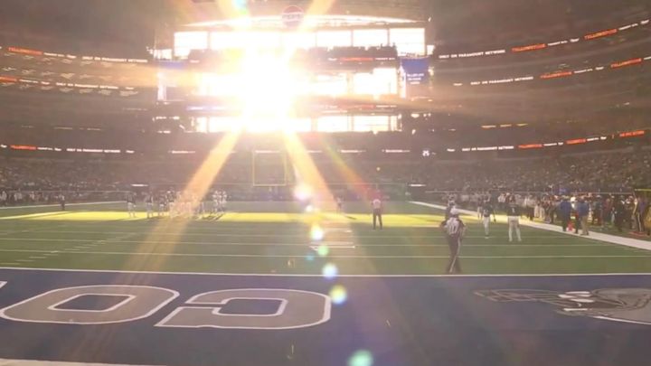 Late-afternoon sun glare through the end zone at AT&T Stadium