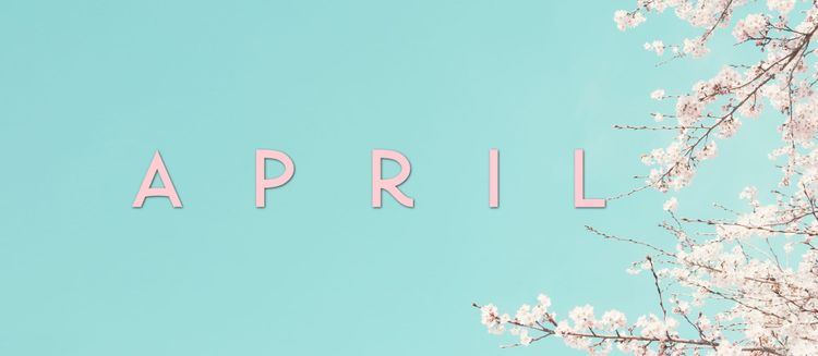 APRIL in pink text over blue sky with pale pink cherry blossom branches on right-hand side