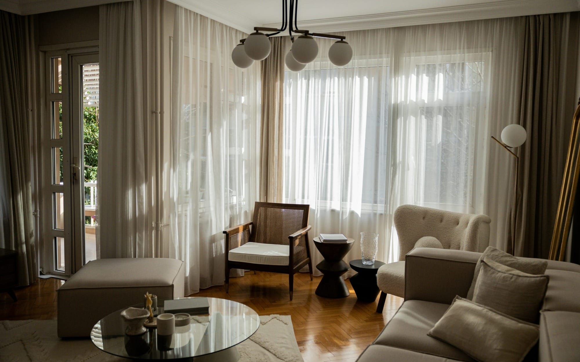 Soft daylight filtering through sheer curtains in a calm living room — representing the gradual shift from daytime cortisol activity toward evening relaxation.