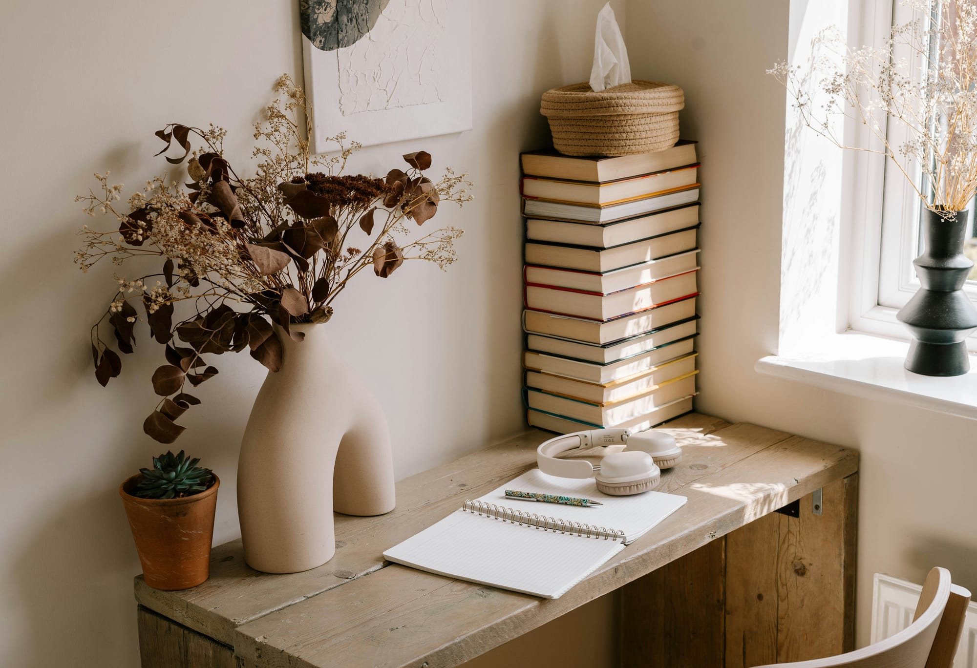 Warm writing desk with books and natural light — a quiet space for medical writing and reflective education.