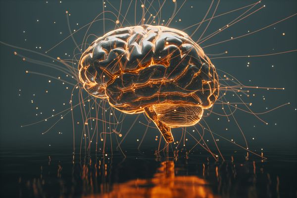 A conceptual 3D digital illustration of a human brain illuminated from within by warm golden light, with glowing neural pathways and acoustic wave particles radiating outward against a minima