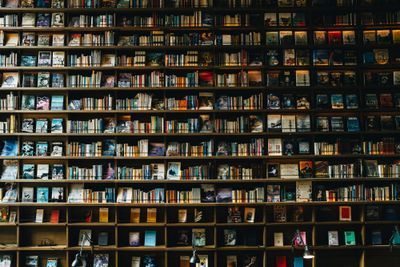 A large bookshelf filled with books, from floor to ceiling