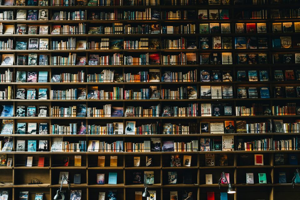 A large bookshelf filled with books, from floor to ceiling